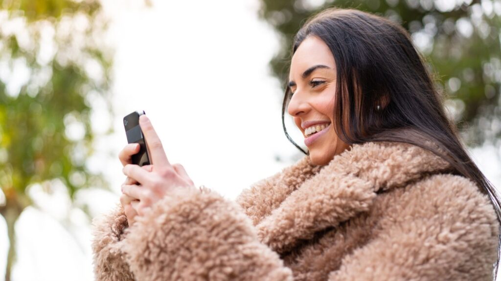 happy woman phone jacket